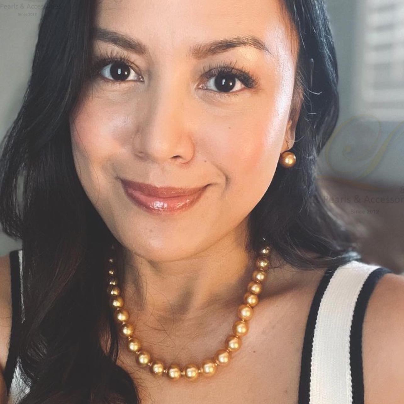 Woman wearing a pearl necklace with a blurred background